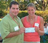 Sevag Yeghoyan, BA'97, Director of the McGill Alumni Association of Toronto, presents first-year McGill student Laura Cornish with the association's Community Service Award in August. This $500 award is given to a student who has demonstrated a love and passion for community service. Despite the blackout that occurred two hours prior to the event and shut down much of southern Ontario and the eastern U.S., 20 first-year undergraduates showed up to meet McGill alumni, current students and fellow frosh and to have last-minute questions answered about Montreal and life at McGill.
