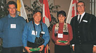 Geoff Blanford, BSc(Agr)'68, James Chen, BSc(Agr)'68, and Joelle Hayek-Juppeau, BSc(FSc)'78, received gifts from Macdonald Homecoming Chair Pierre Langlois, BS(Agr)'78 (far right),  as the graduates who had traveled furthest to get to the Mac reunion.