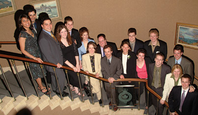 Members of the McGill Young Alumni pose on the staircase of the St. James's Club before accepting the award for Event of the Year.