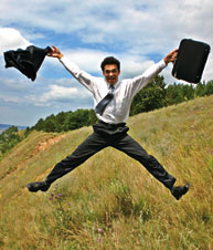 Man in suit jumping for joy.