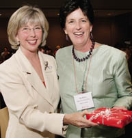 Changing of the guard: outgoing Alumni Association president Morna Flood Consedine, DipEd'71, MEd'77, DEd'85 (right), handed over the reins to successor (and the evening's master of ceremonies) Ann Vroom, BA'67, but not before receiving a gift from the MAA in appreciation of her many contributions.