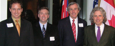 The four men pose briefly for the camera.