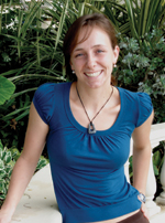 Katherine Trajan smiling in the greenhouse.